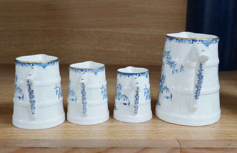 A graduated set of four Royal Worcester blue and white jugs, tallest 11cm. Condition - good.